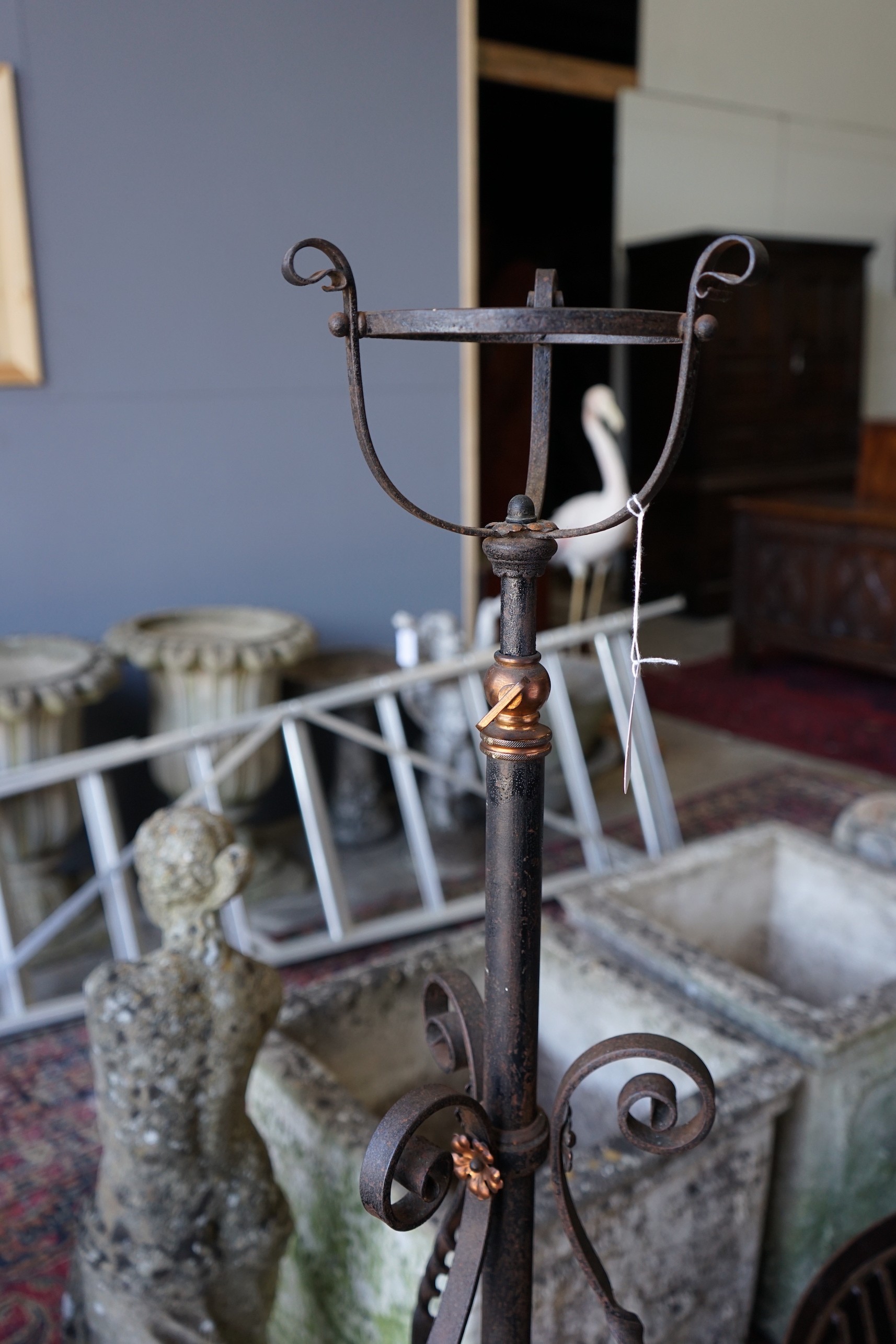 An early 20th century copper mounted wrought iron telescopic oil lamp standard